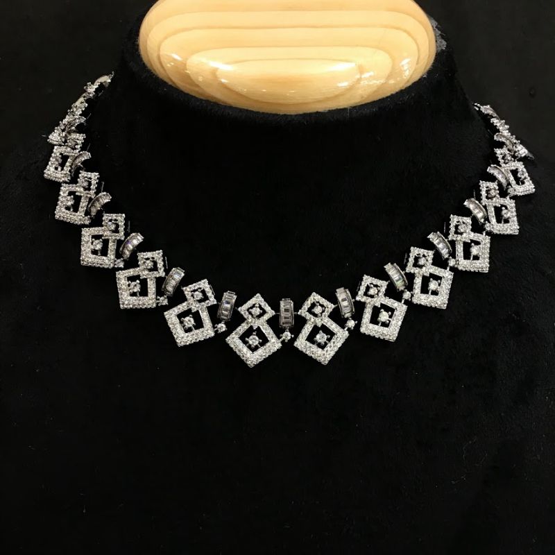 Emerald Cut diamond pendant and earrings set in 18K gold